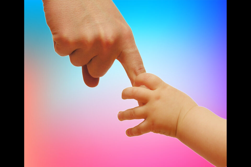 touching baby’s hand